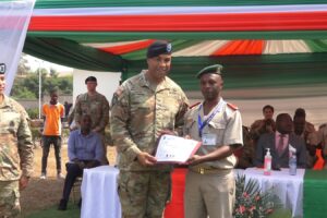 A representative of the Burundian army general staff awards a certificate to a US army soldier after joint training with her Burundian peers, August 2024