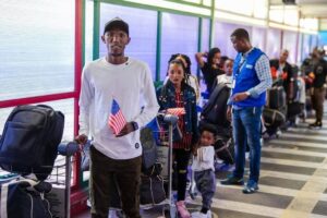 Congolese refugees queuing at an airport for the United States, Dr.