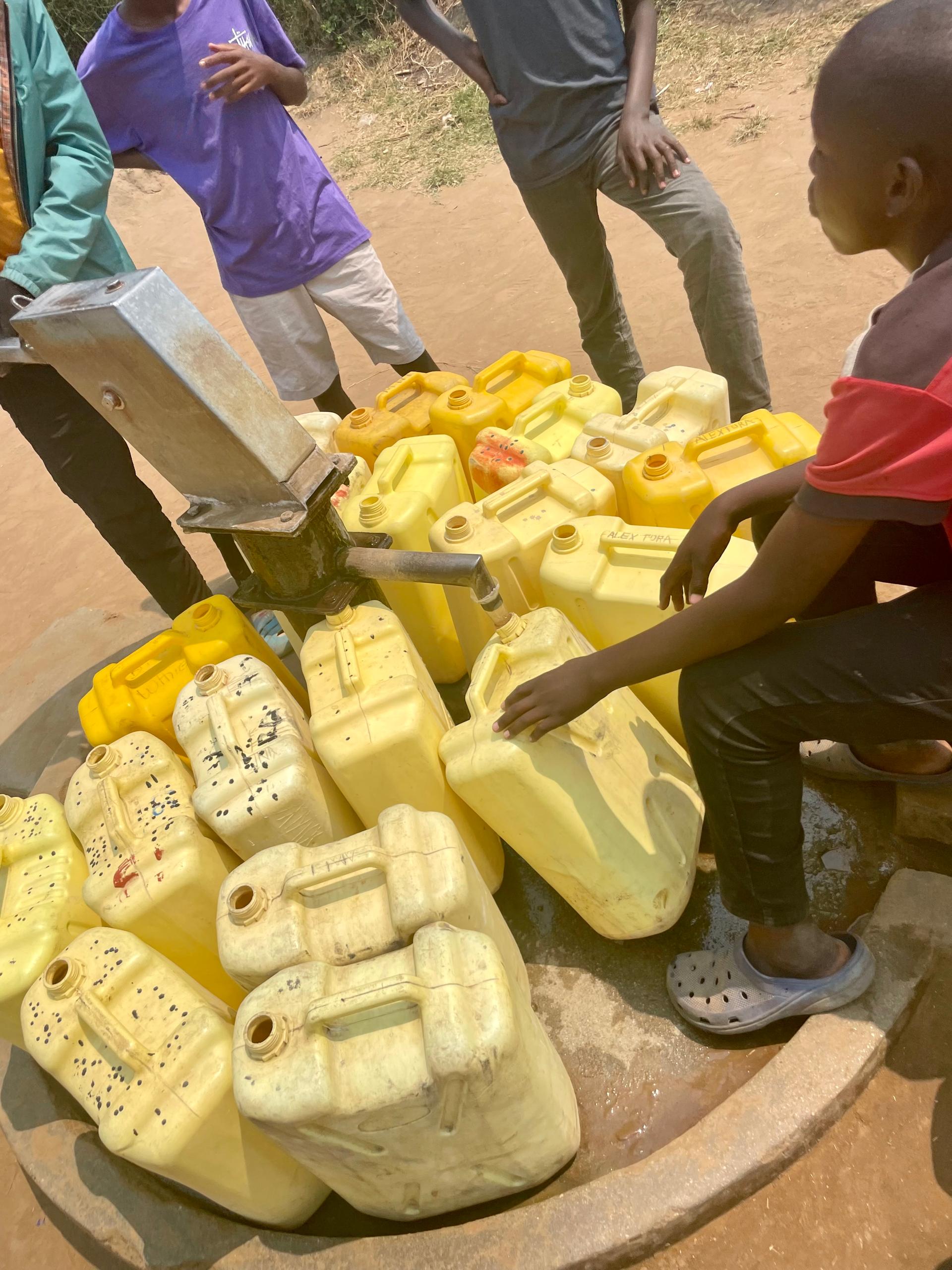Refugees on a water fountain in the Nakivale camp in Uganda, DR
