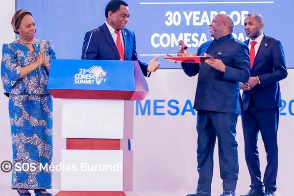 Burundian President Évariste Ndayishimiye receives the baton of command from his Zambian counterpart Hakainde Hichilema