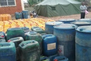 A man inspects the quantity of fuel given to the local police by SNR agents, DR