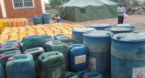 A man inspects the quantity of fuel given to the local police by SNR agents, DR