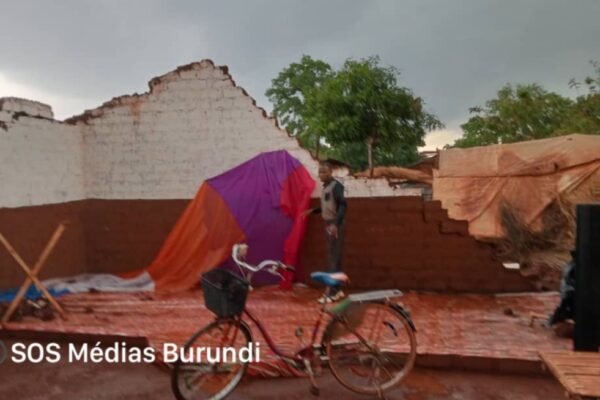 A man stands in the ruins of a house destroyed by torrential rains in Nyarugusu, October 2024 (SOS Médias Burundi)