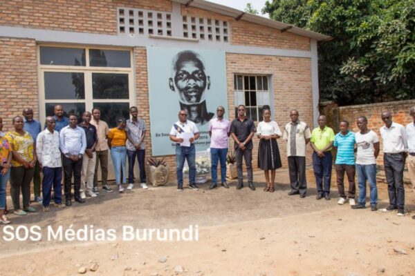 Des salariés du groupe de presse Iwacu réunis dans la cour intérieure devant le portrait de Jean Bigirimana, disparu le 22 juillet 2016, lors d’un recueillement organisé le 23 juillet 2024 à Bujumbura © SOS Médias Burundi